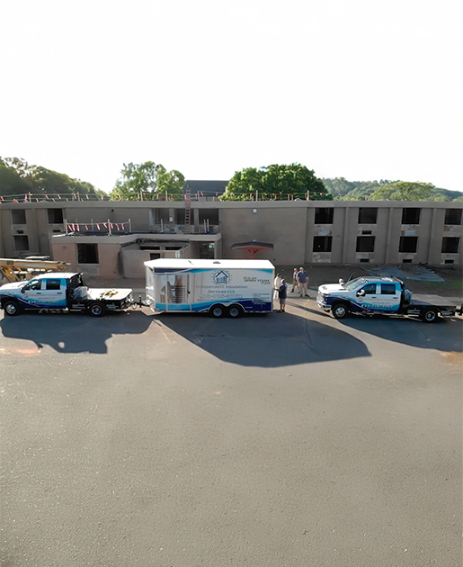 Independent Insulation trucks and trailer at a construction project